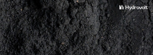 A close-up of fine, dark black powder with the Hydrovolt logo in the top right corner.